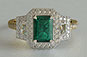 three-stone engagement ring, emerald cut emerald, trapezoid diamonds, yellow gold