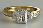 Radiant Cut Diamond and Trapezoid Three-stone Engagement Ring in Yellow Gold